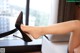 A woman's legs in high heels sitting on a chair.