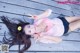 A woman laying on a wooden floor with her hair blowing in the wind.