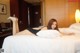 A woman laying on a bed in a hotel room.