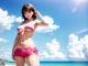 A woman in a pink bikini standing on a beach.