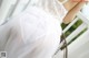 A woman wearing a white dress with chinese writing on it.